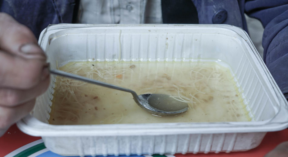 High angle view of person eating soup