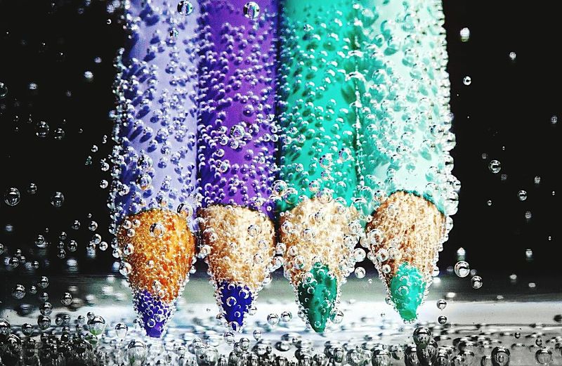 Colorful pencils in water