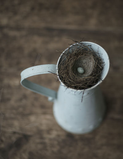 High angle view of egg in nest on jug