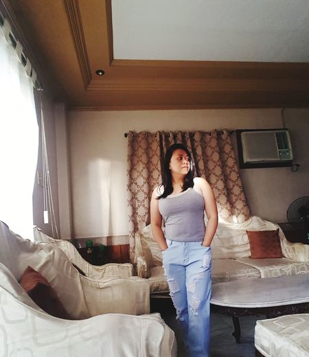 Portrait of woman standing at home