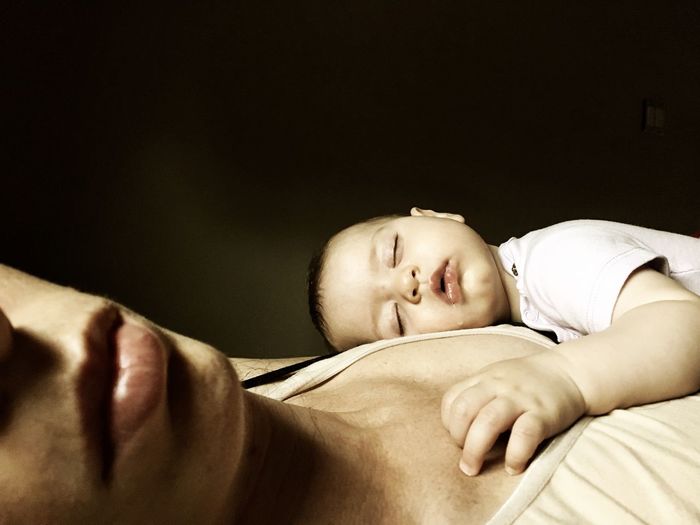 Mother and daughter sleeping in bed