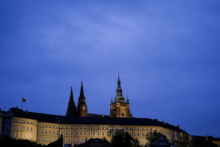 Buildings in city against blue sky