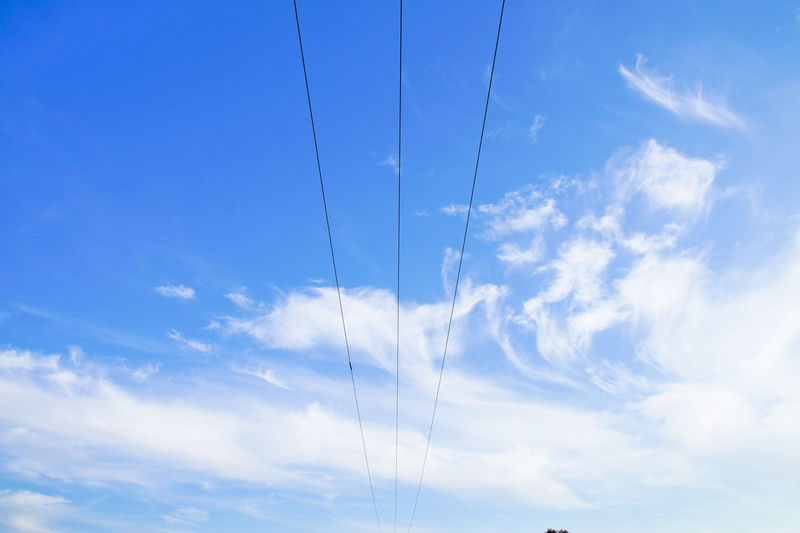 Low angle view of cable against blue sky