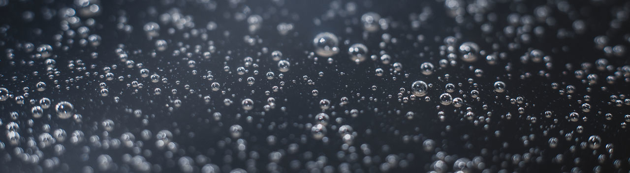 Panoramic photo background of air bubbles on the water surface.