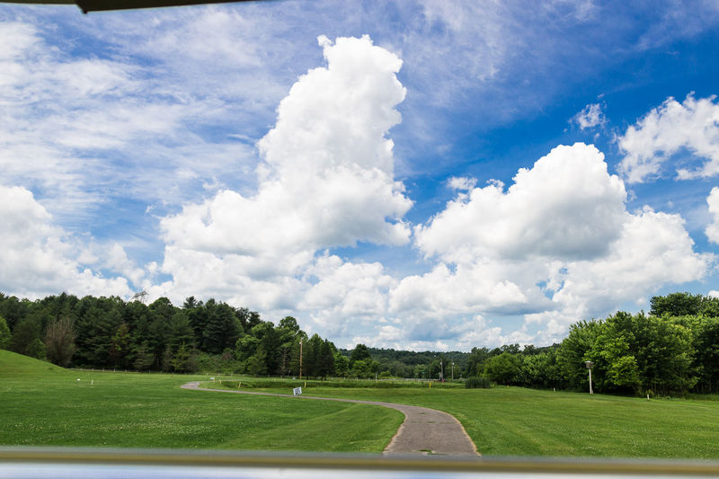 Scenic view of golf course against sky