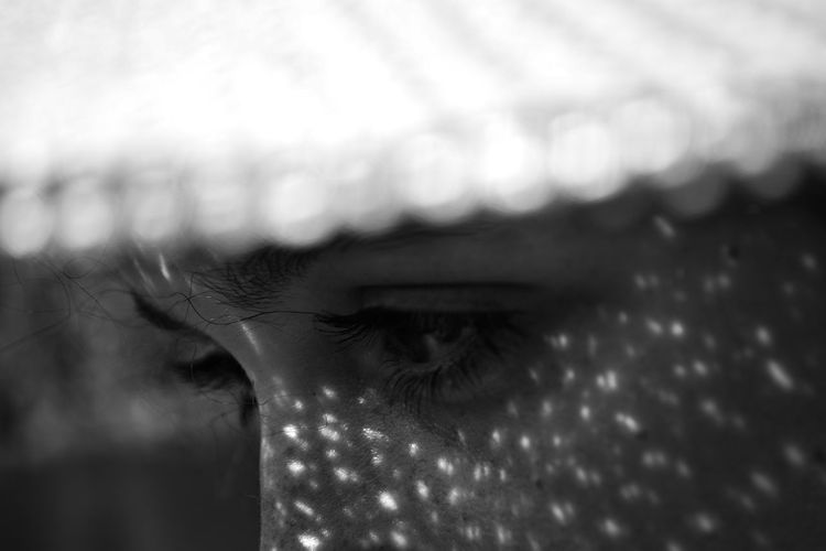 Close-up of woman looking away against blurred background