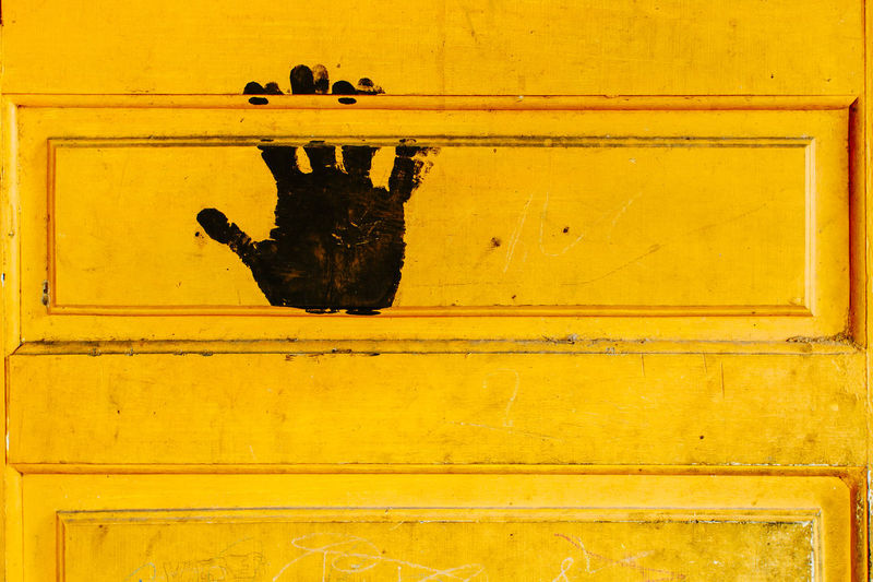 Close-up of black print on yellow door 