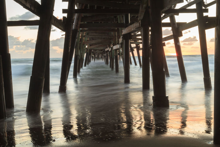 Low angle view of bridge at calm sea