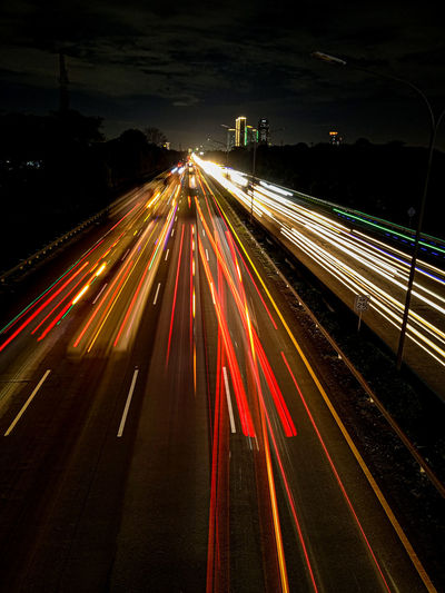 High angle view of light trails on road at night