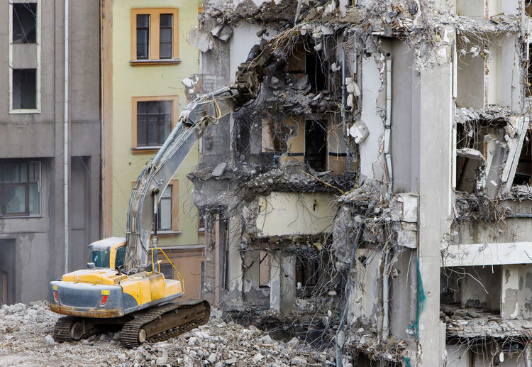 Building of former hotel demolition for new construction, usingspecial hydraulic excavator-destroyer