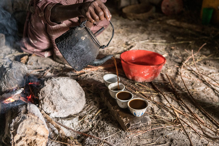 Man pouring coffee in cups