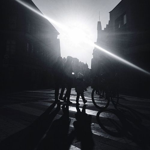 Silhouette of people in city