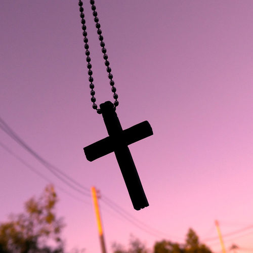 Low angle view of silhouette cross against sky during sunset