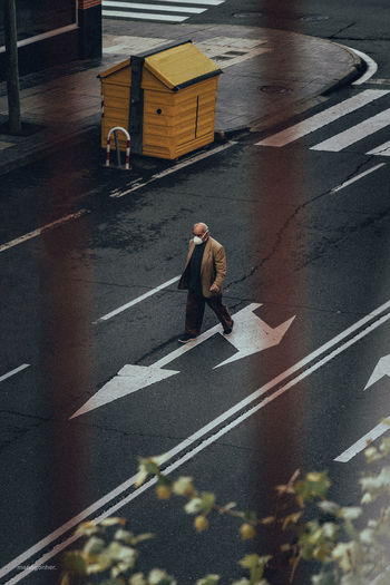 High angle view of man walking on road