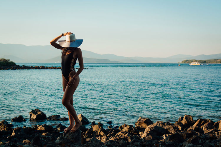 Woman standing in swimwear at beach