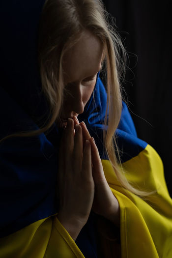 Woman praying, god save ukraine