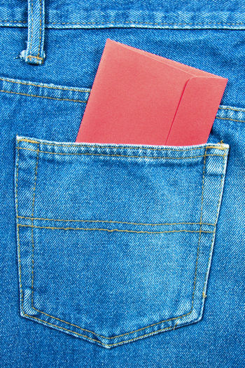 Close-up of letter in jeans pocket