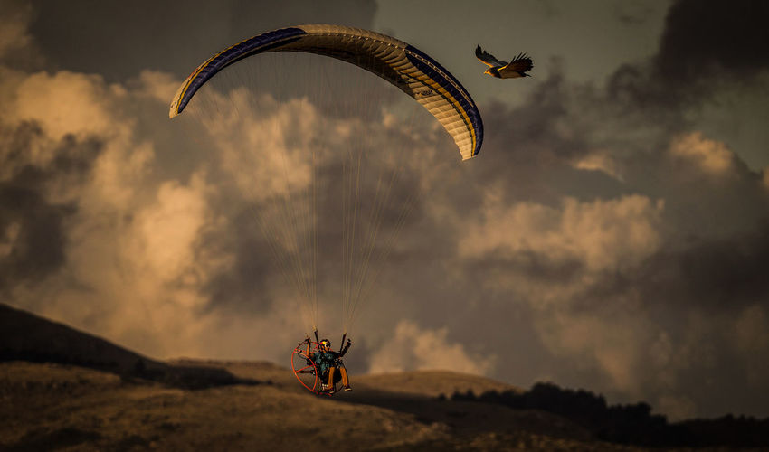 Full length of an paragliding against sky