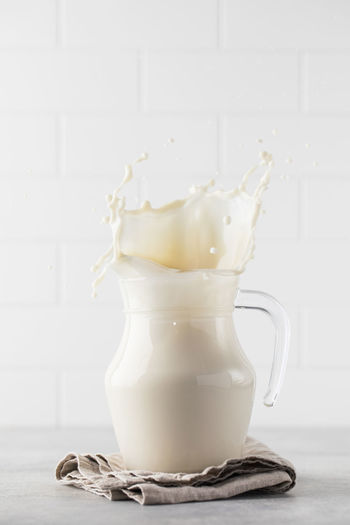 Splash and splash in a jug of vegetable milk. the concept of a healthy lifestyle.