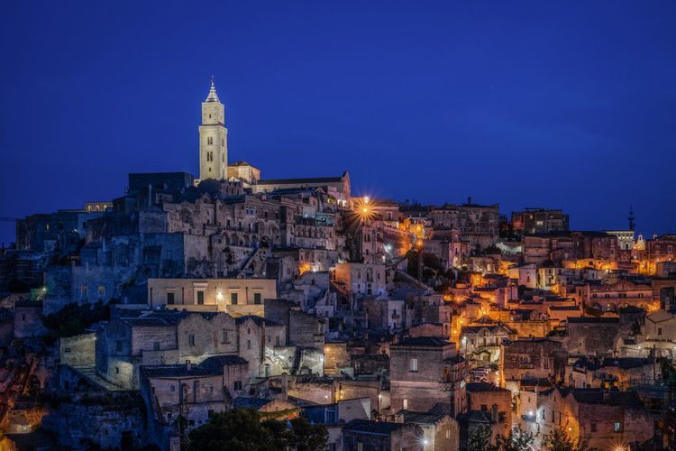 Scenic night view at blue hour of matera with the illuminated bell tower of matera cathedral