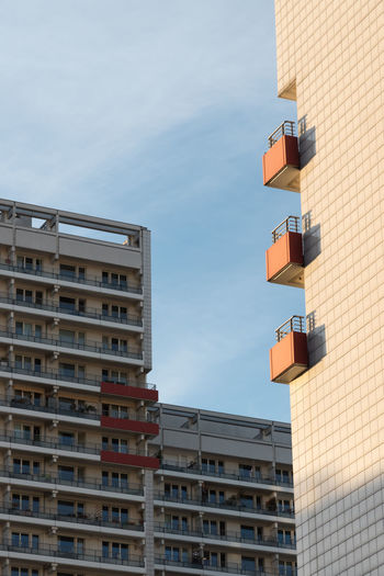 Three balconies on the sunny side of an apartment building