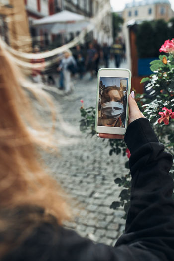 Close-up of woman video calling while standing outdoors