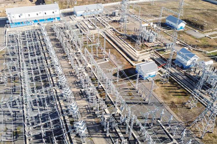 High-voltage electric transformation power plant. high-voltage power lines on pylons and transformer