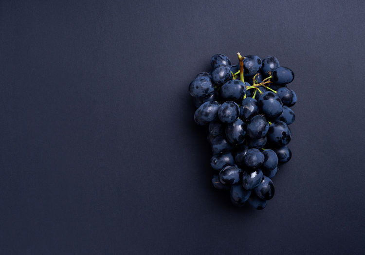 High angle view of grapes over black background