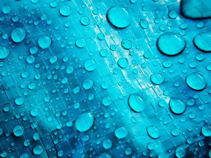 Close-up of water drops on plastic tarp