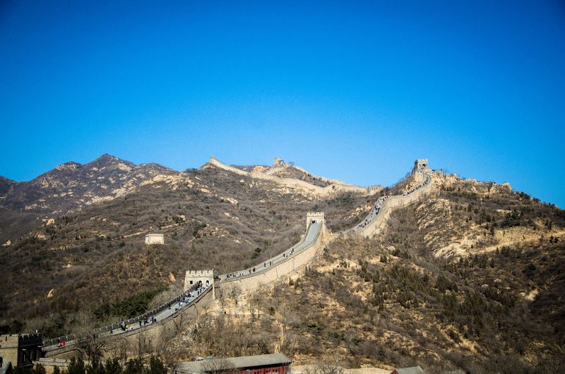 View of great wall of china and mountains against clear blue sky