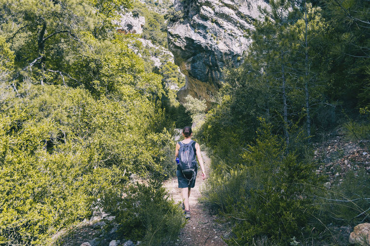 Woman hiking on a mountain path in catalonia on a cloudy summer day