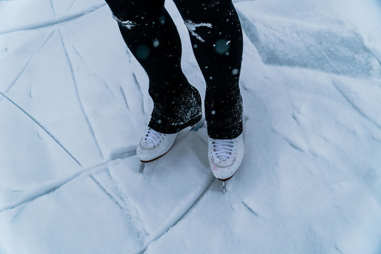 Low section of person standing on snow
