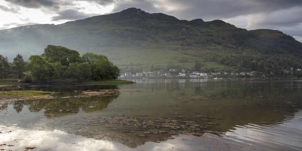 Scenic view of lake and mountains against sky
