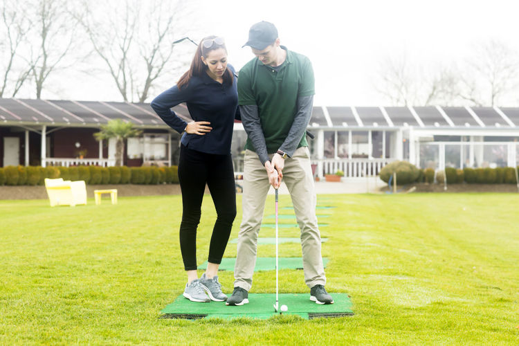 Young couple playing golf together