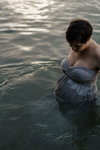 High angle view of pregnant woman at lake