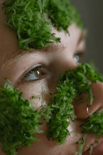 Close up of woman with cucumber face pack