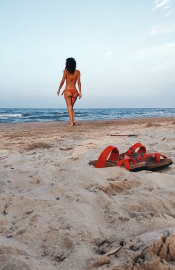 Full length of beautiful womand in bikini  standing on beach