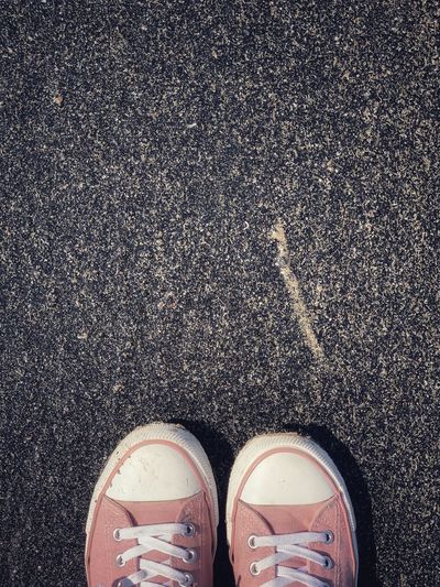 Low section of person standing on road