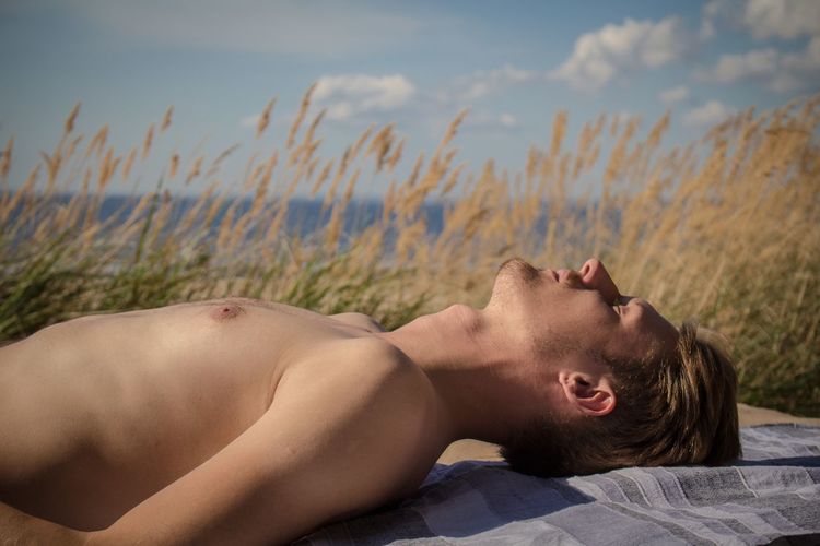 Man relaxing on beach towel