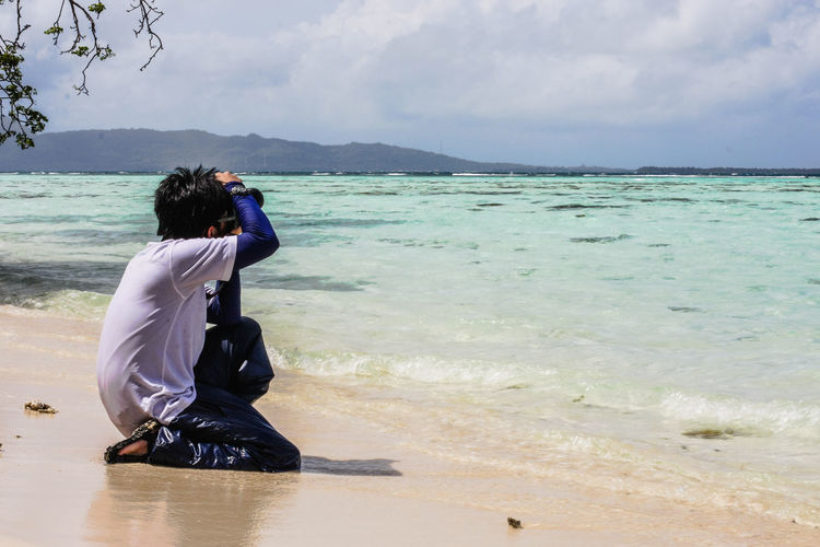 Boy photographing at beach