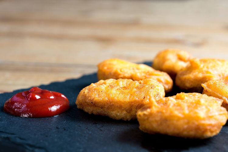 Close-up of fresh nuggets with ketchup served on table