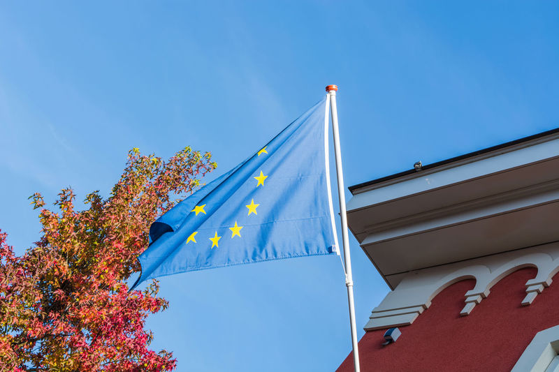 Low angle view of european union flag against clear blue sky