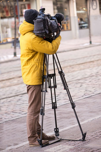 Man with film camera on street