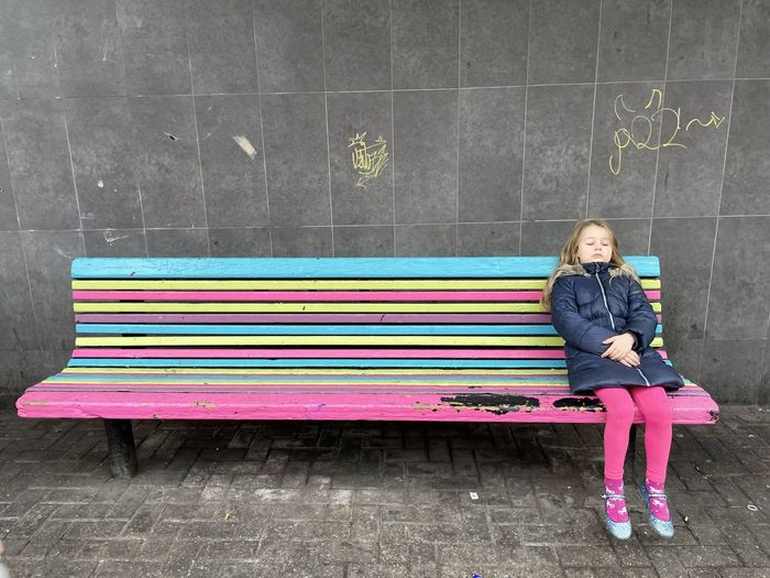 Rear view of man sitting on bench