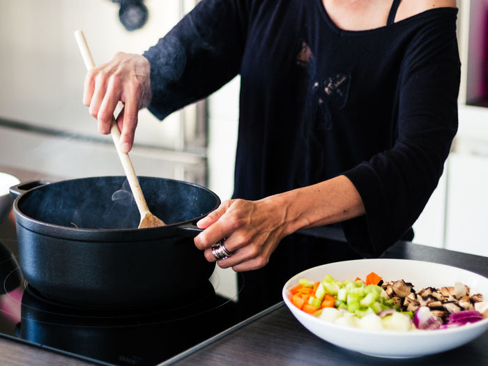 Midsection of woman preparing food in kitchen