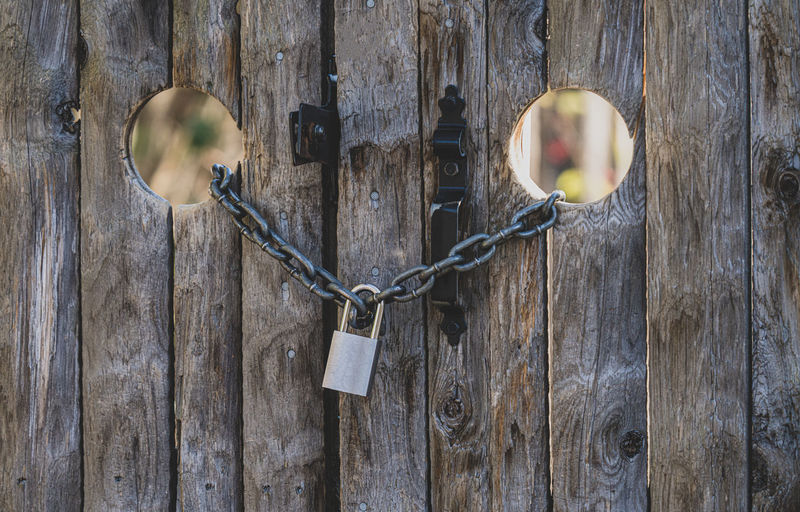 Old doors have been locked with a chain and padlock