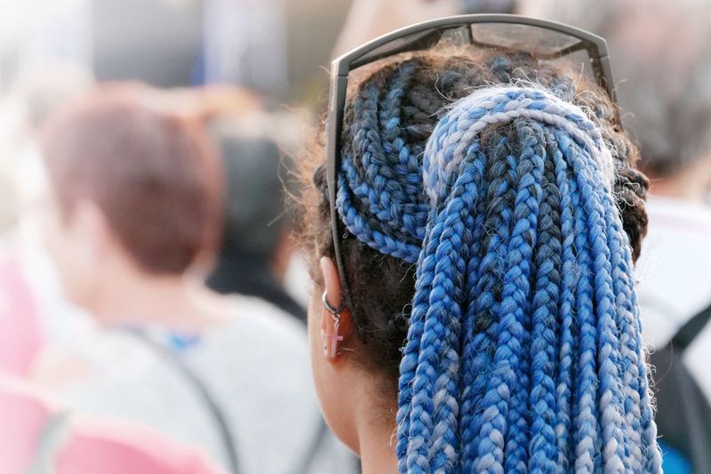Rear view of woman with blue braided hair
