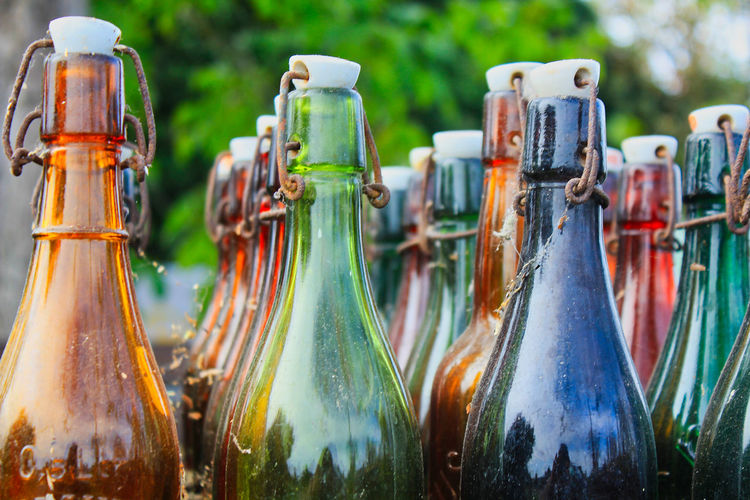 Close-up of empty bottles at yard
