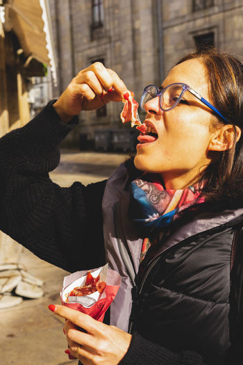 Woman eats on the street