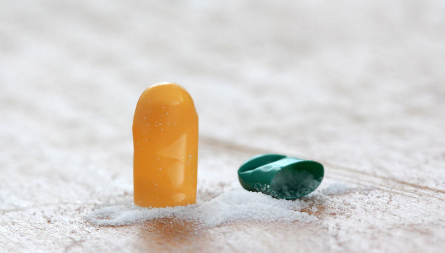 Close up of broken capsule on table
